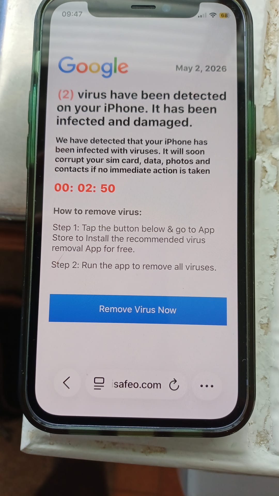 An iPhone displaying a fake warning An iPhone sits on a surface displaying a web page. The page displays a Google logo and states that ‘(2) virus have been detected on your iPhone. It has been infected and damaged.’